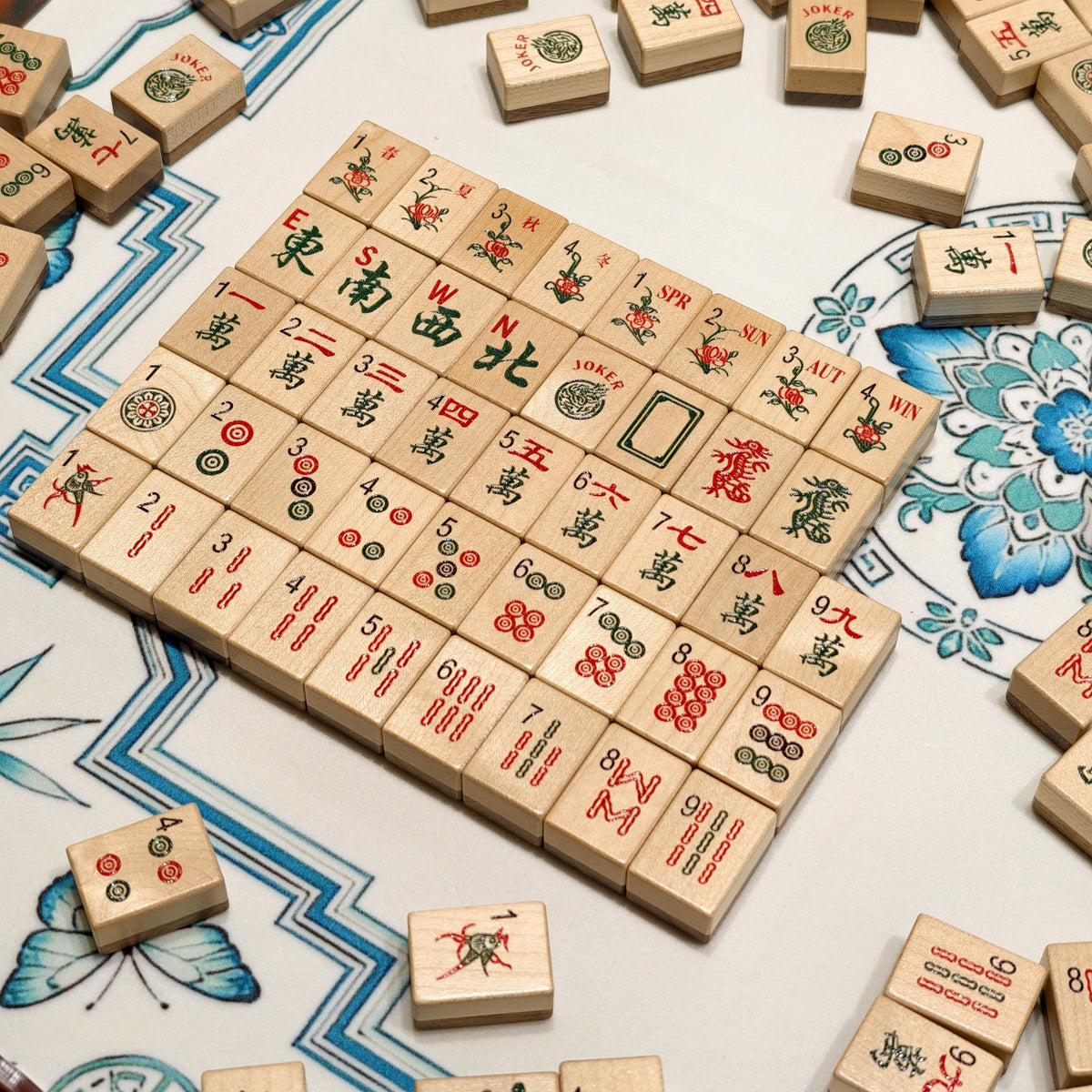 Wood Harmony American Mahjong tiles arranged in a rack on a blue floral mat