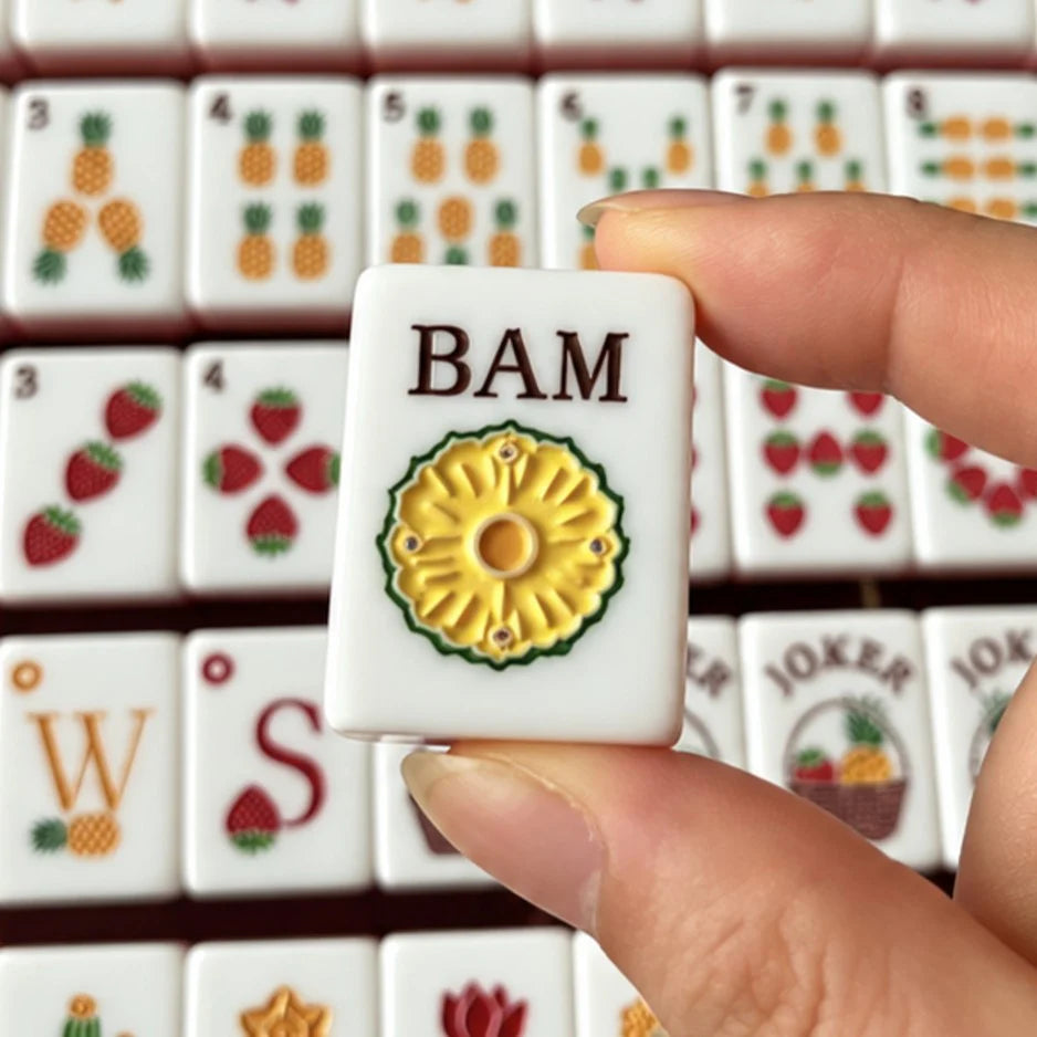 Close-up of the Orchard Pearl BAM tile with fruit-inspired artwork